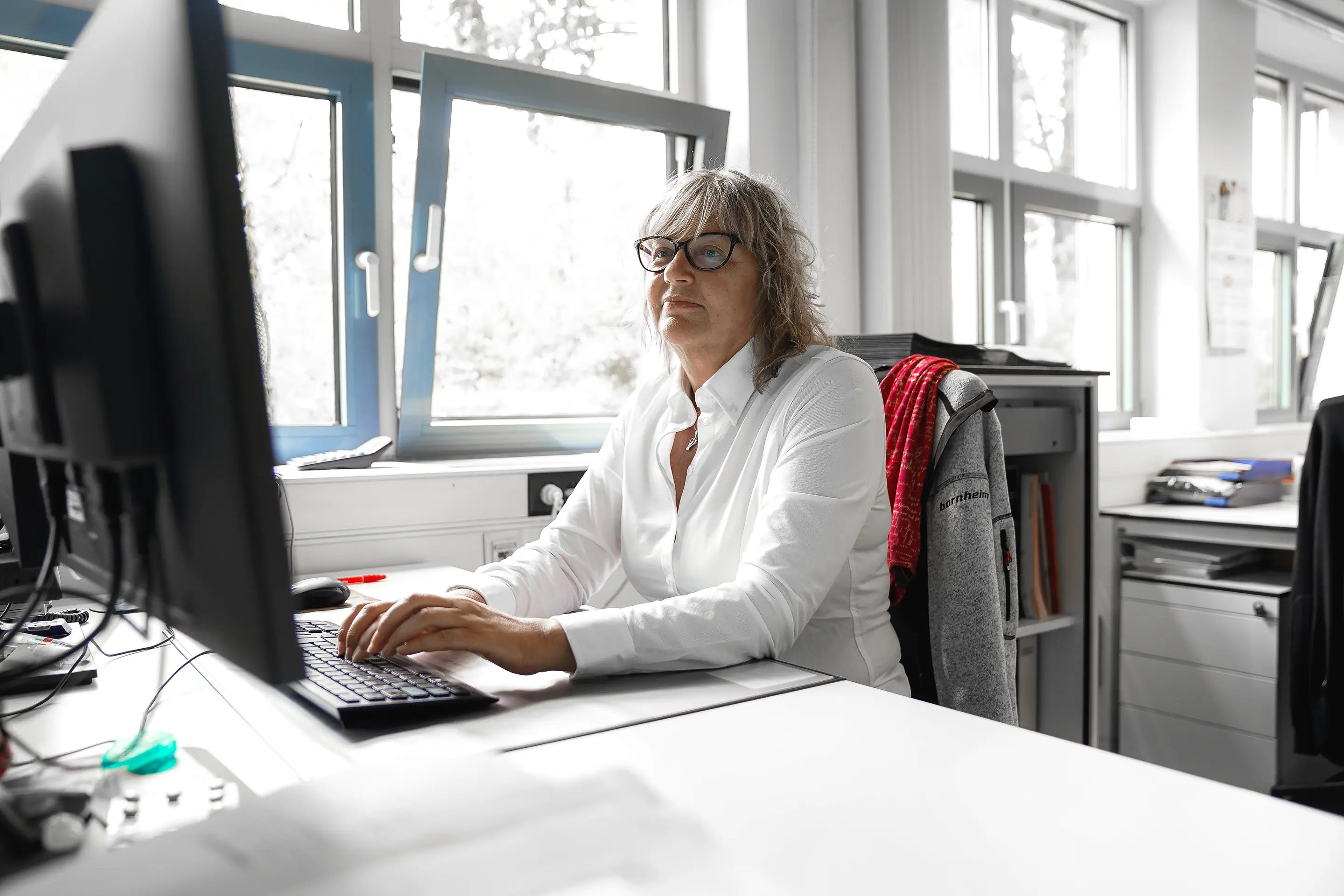 Portraitfoto Gabriele Ouda am Arbeitsplatz